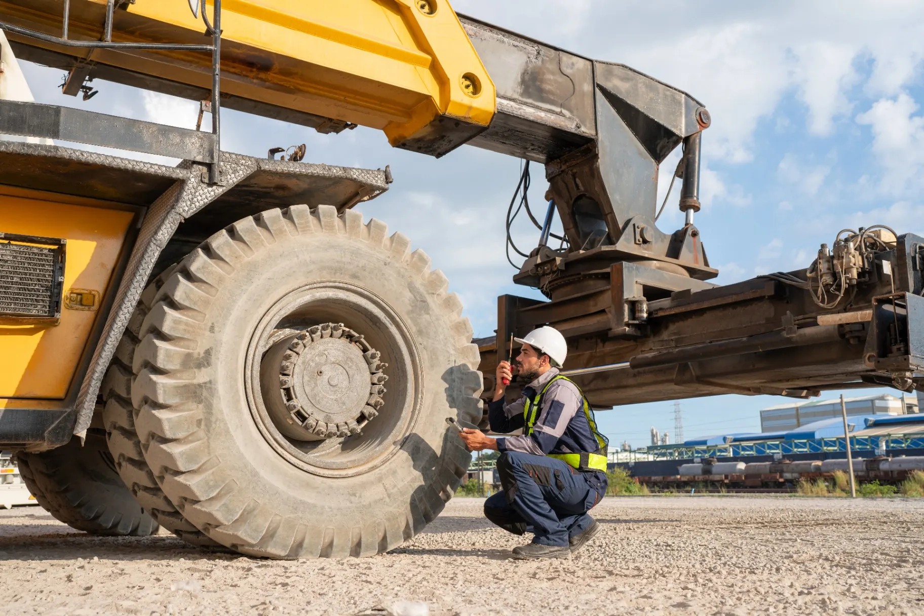 Technician inspecting the wheel of a haul truck
